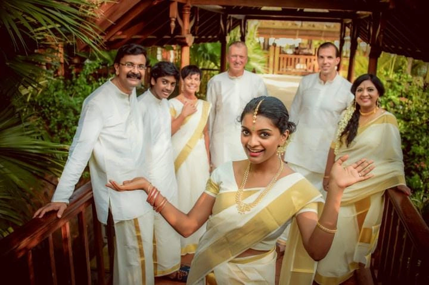 A group in Kerala traditional attire, with gold-bordered set sarees and mundus